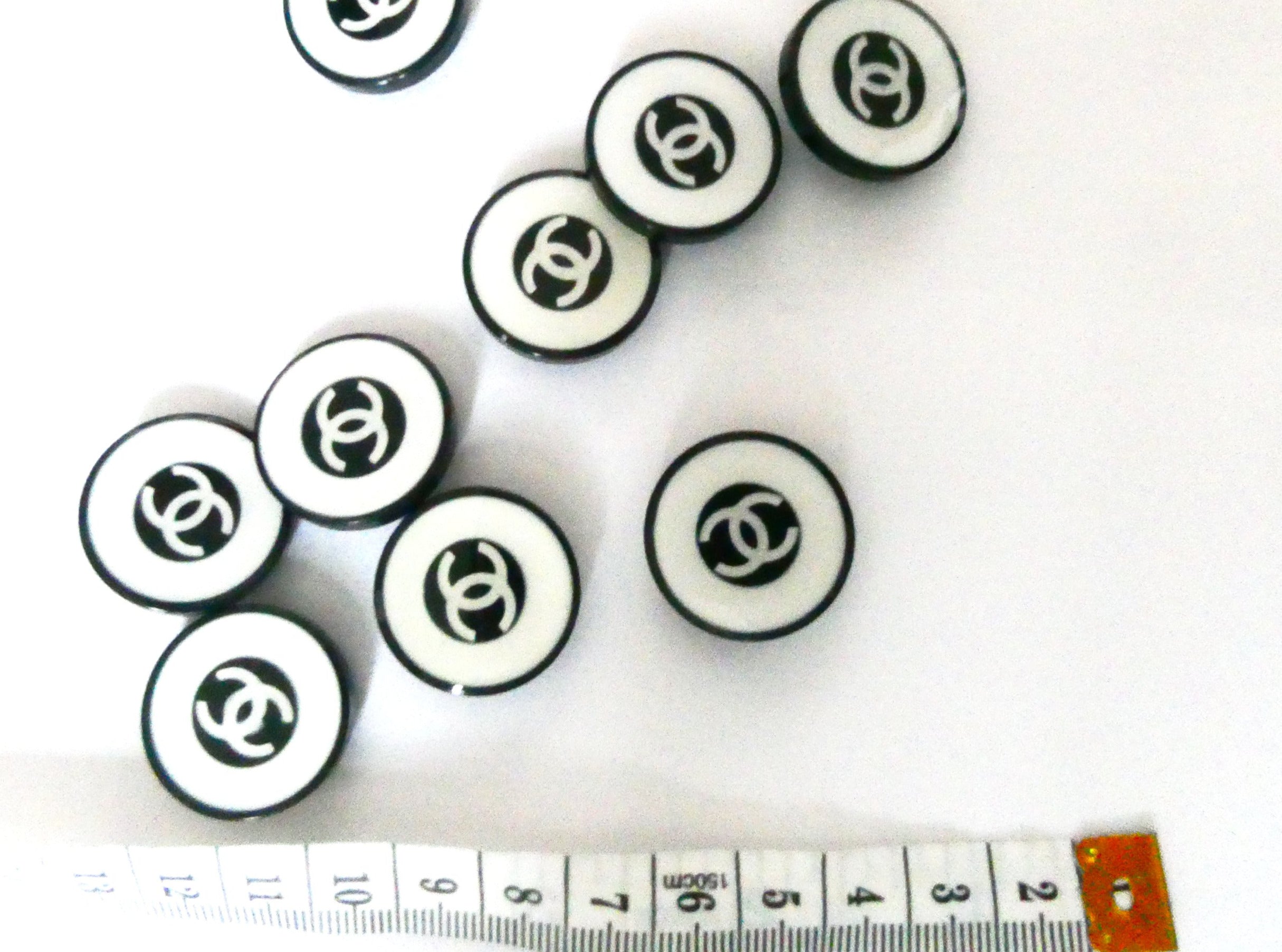 Lot 232 - Sixty-five Chanel buttons, mainly 1992-97